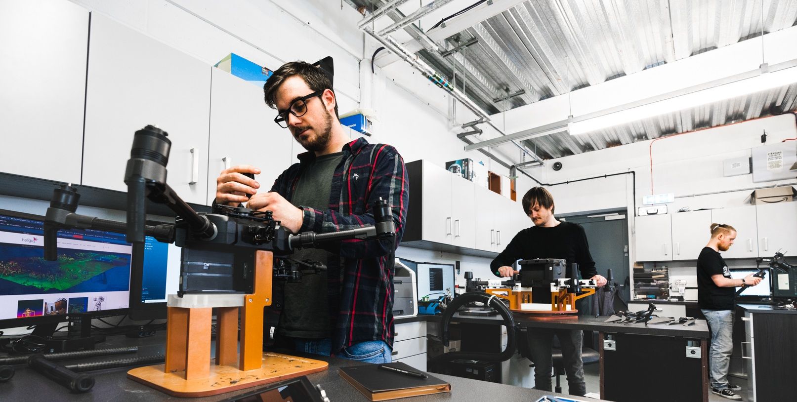 Inside the heliguy repair workshop — technicians at the bench